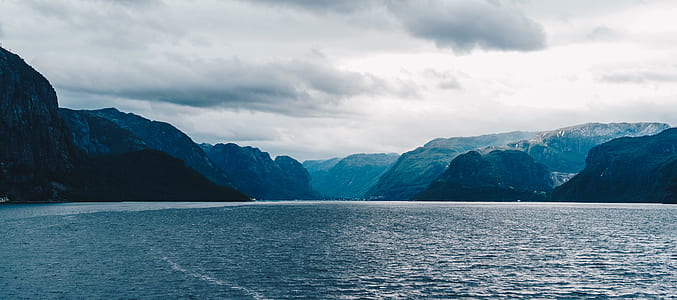 landscape photography of body of water near mountains thumbnail