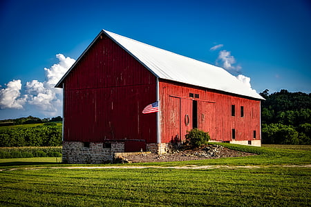 red and white wooden shed near forest during daytime thumbnail