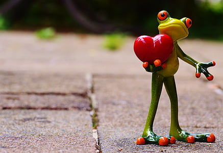 green frog holding red heart ceramic figurine thumbnail