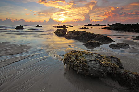 Sea Rock Under White Clouds Blue Skies during Sunset thumbnail