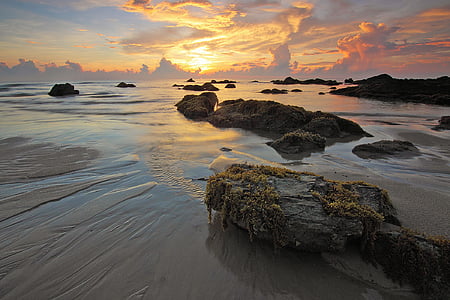 rocks on sea during sun set thumbnail