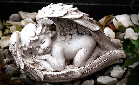 close up photography of sleeping baby angel figurine thumbnail