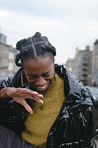 woman wearing yellow shirt and black jacket thumbnail