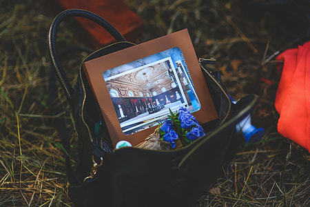 opened black leather shoulder bag with digital photo frame thumbnail