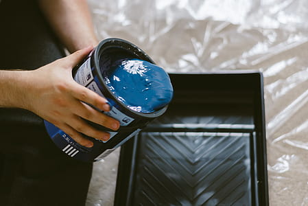 Person Holding Can of Blue Paint thumbnail