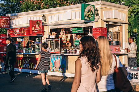 two woman near food stall during daytime thumbnail