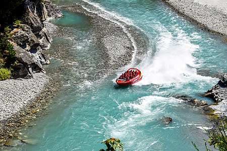 people riding inflatable boat on body of water thumbnail