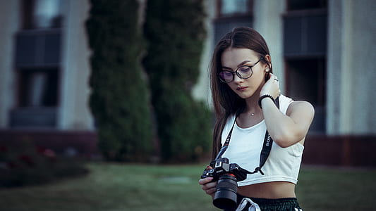woman holding camera at daytime thumbnail