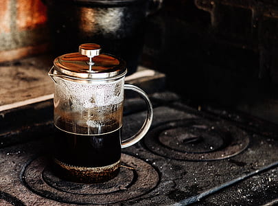 clear glass teapot on black metal surface thumbnail