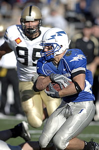 football player playing on field thumbnail