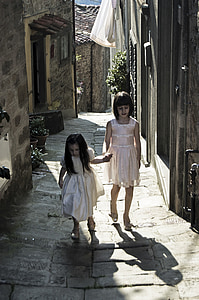 two girls walking on road during daytime thumbnail