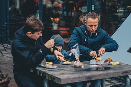 people eating outside on picnic table thumbnail