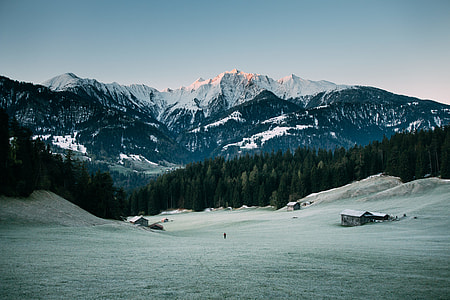 snow capped mountain taken under white clouds thumbnail