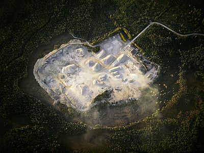 bird's eye view photography of island surrounded by trees thumbnail
