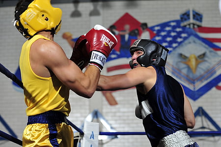 two men boxing on blue roped ring thumbnail