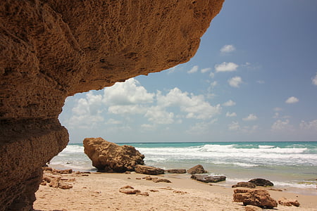 brown stones beside sea during daytime photography thumbnail