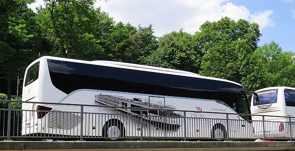 white bus parked beside road thumbnail