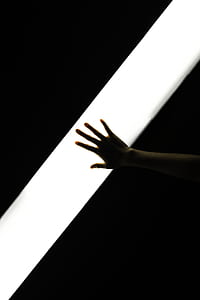 person's right hand tap on white light in dark room thumbnail