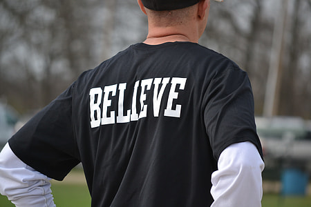 back view of man in black Believe-printed shirt thumbnail