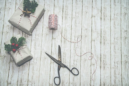 black steel scissors on gray wood planks thumbnail