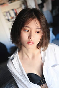 selective focus photo of woman wearing black collared button-up shirt and black lace-up bra thumbnail