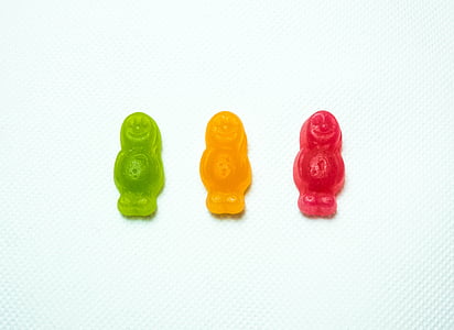 three assorted-color person figures on white surface thumbnail