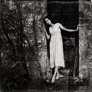 woman wearing midi dress standing in the middle of two walls thumbnail