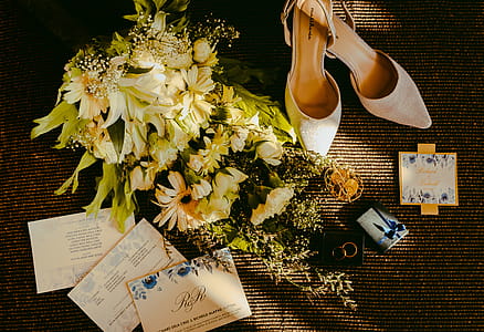 Pair Of Beige Shoes Beside Bouquet thumbnail