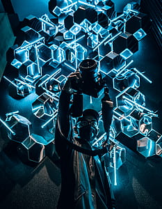 man holding DSLR camera near neon signage thumbnail