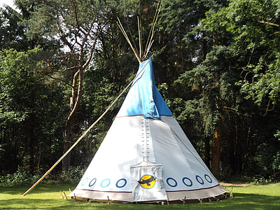 white and blue teepee tent near green trees thumbnail