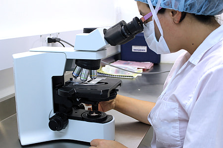 woman using microscope inside laboratory thumbnail