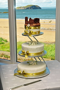 white three-tier cake on white table thumbnail