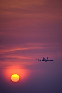 white airplane flying during sunset thumbnail