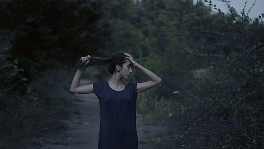 woman holding hair thumbnail