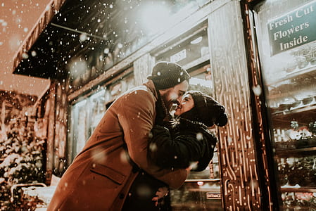 photo of man and woman wearing black knit caps thumbnail