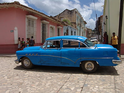 blue sedan park near house during daytime thumbnail