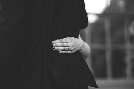 person touching textile greyscale photography thumbnail