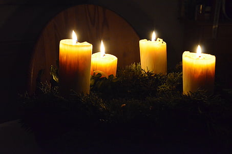 four lighted pillar candles thumbnail