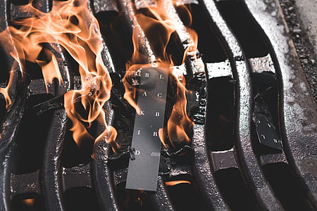 black product tag burning on black grill thumbnail