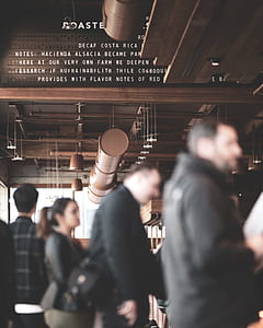people wearing black jackets standing inside room thumbnail
