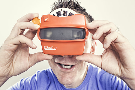 man in blue crew-neck shirt holding Orange master goggles thumbnail