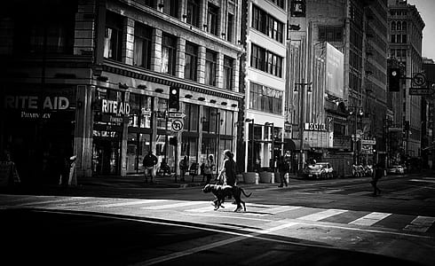 grayscale photo of woman crossing street thumbnail