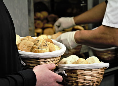 man holding basket with bread inside bakeshop thumbnail