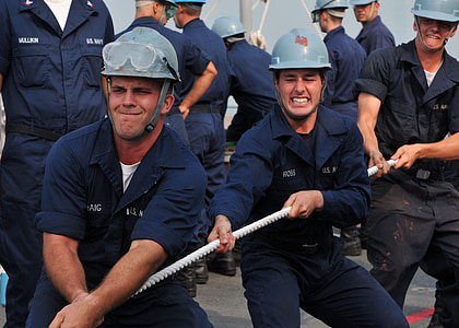 men wearing hard hats pulling rope near men thumbnail