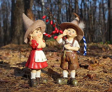 two Hummel girl and boy figurines placed on ground thumbnail