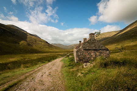brown concrete house on green grass field thumbnail