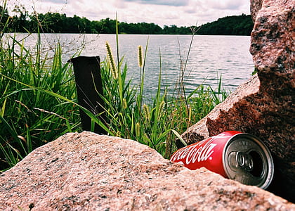 Coca-Cola can in front of body of water thumbnail