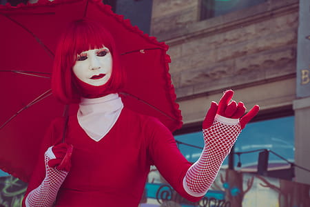 Woman Wearing Red Long-sleeved Shirt and Red Wig While Holding Red Umbrella thumbnail
