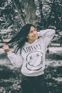 woman flipping her hair while standing under tree thumbnail