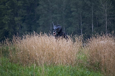 person in black top holding paintball gun thumbnail